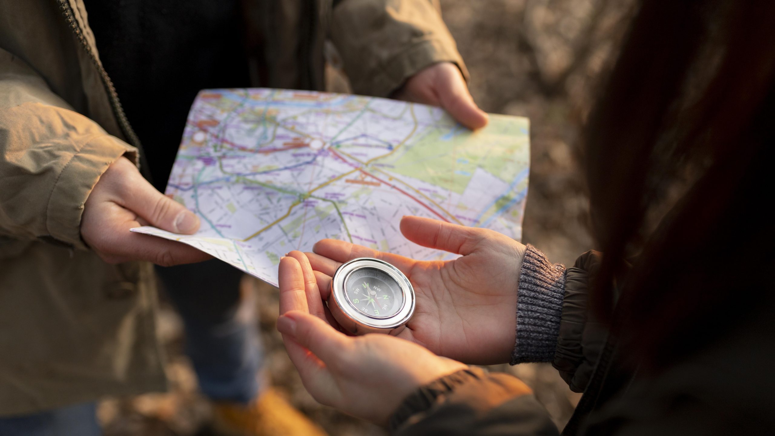 close up travelers with map compass scaled